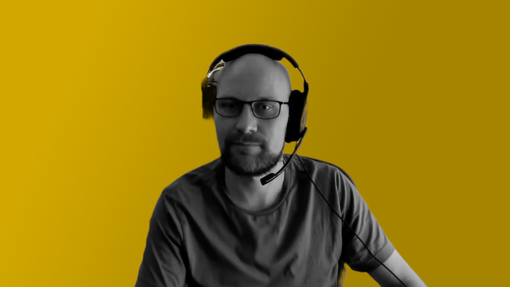 Ejnar Håkonsen looks at the camera with a headset on.